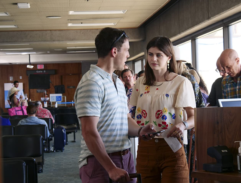 A still from the HBO Max TV show "The White Lotus" featuring Rachel (Alexandra Daddario) and Shane (Jake Lacy) waiting to board their flight home after their week-long vacation. This image is featured in Sky Bird Travel & Tours blog article "On Location: The White Lotus," which shows the movie destinations that you can see in real-life.