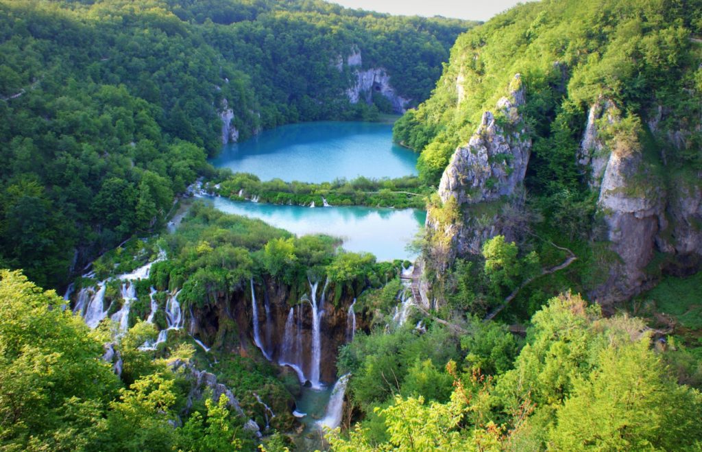Plitvice Lakes National Park in Karlovac, Croatia has been declared a top 10 national park to visit in 2023 around the world! In this photo, the parks beauty is captured in a bright blue lake falling down a cliff in a dozen different waterfall steams.