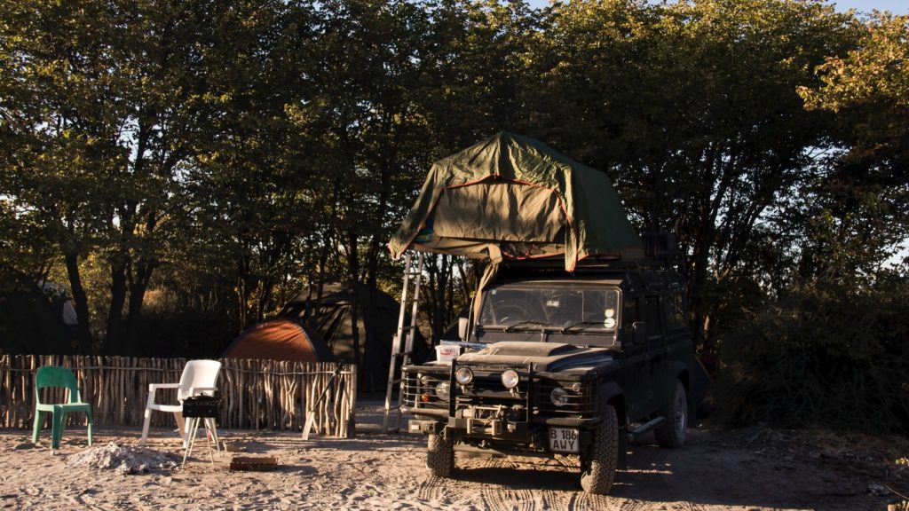 A landscape shot of a jeep van with a tent for camping at the Makgadikgadi Salt Pans. This image is featured in the Sky Bird Travel & Tours blog, "Africa's Top Landmarks," which describes the best things to do and see on vacation in Africa.