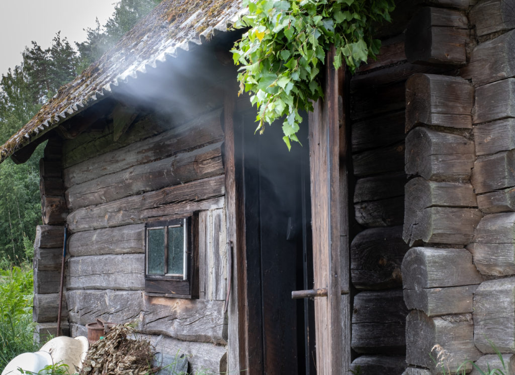 A shot of a traditional smoke sauna in Southern Estonia, which is used for smoking meats and steaming with large or small groups of travelers. This image is featured in the Sky Bird Travel & Tours blog post, "Top 10 Destination: The Baltics," which describes the best things to do while on vacation in the Baltic States.