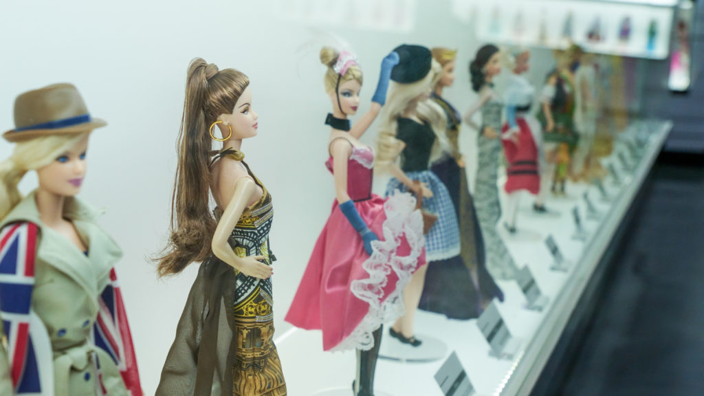 This image featured in sky bird blog "On Location: Barbie" shows Barbie Expo display at downtown mall Les Cours Mont Royal, fashion stylish clothes of history. Large fashion exhibit of Barbie Dolls on display