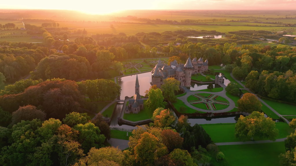 This image of Kasteel de Haar in Utrecht Austria Netherlands which is a castle in the fall setting, which is featured in the Sky Bird Travel & Tours blog post "Autumn Vacation Destinations"