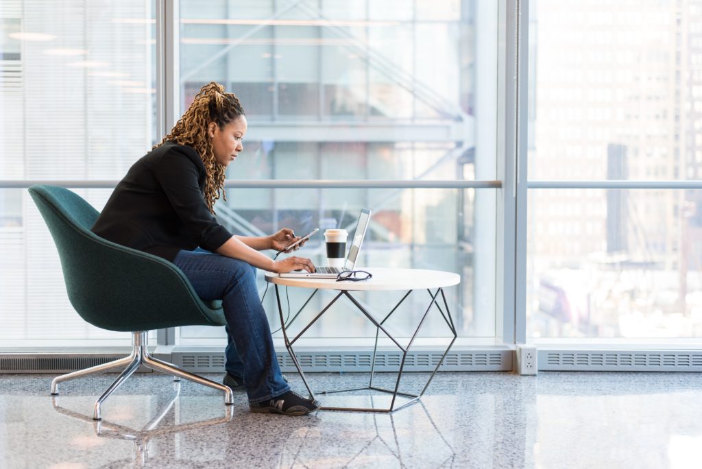 featured in sky bird's "benefits of booking with sky bird" blog, the image shows a lady working on her laptop.