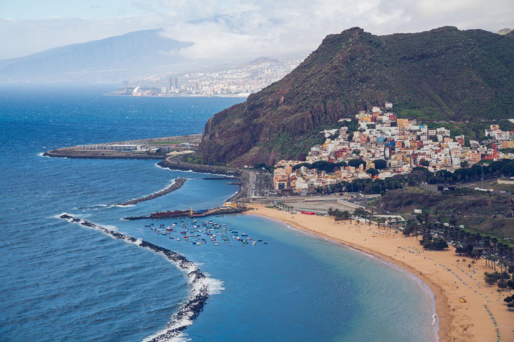 Featured in 2023 Winter Vacation Destinations from Sky Bird Travel & Tours, this image shows the beach and islands of Tenerife Spain.