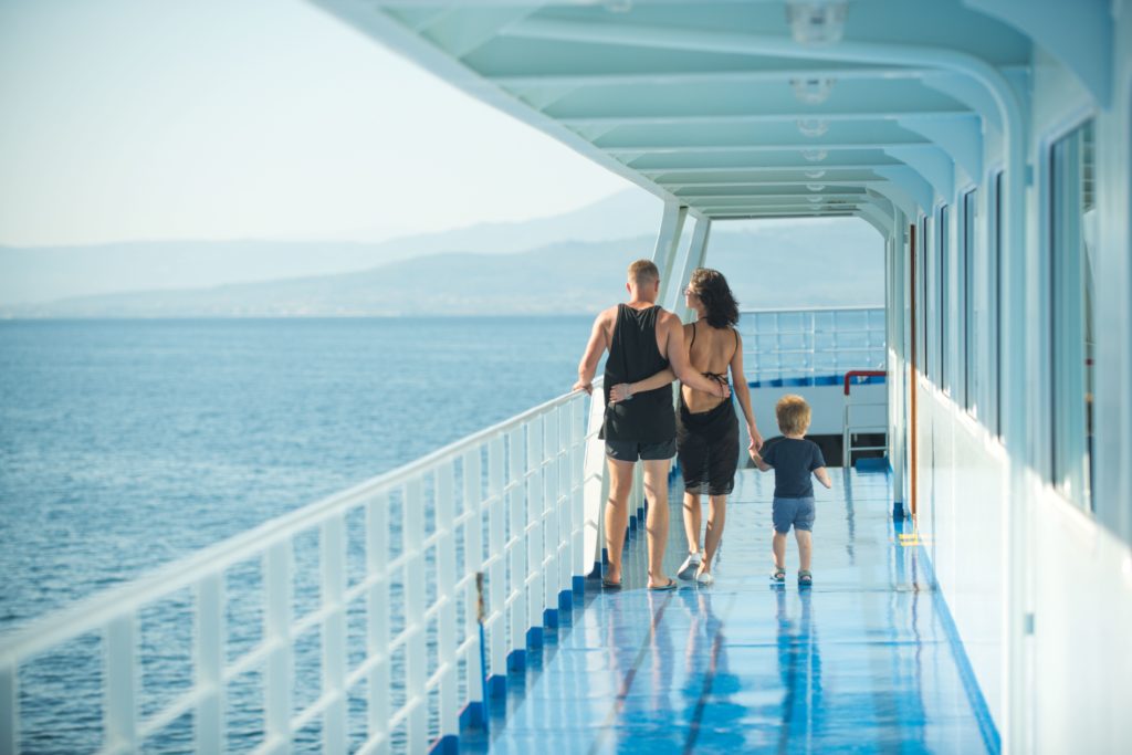 Featured in Discovering Niche Markets by Sky Bird Travel & Tours, this image shows a family walking on a cruise ship.