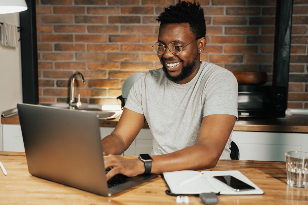 Featured in Discovering Niche Markets by Sky Bird Travel & Tours, this image shows a man typing on his laptop.