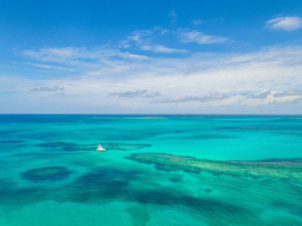 Featured in the blog "Top 10 Destination: The Bahamas" by Sky Bird Travel & Tours, this image shows the Sandy Toes Beach.