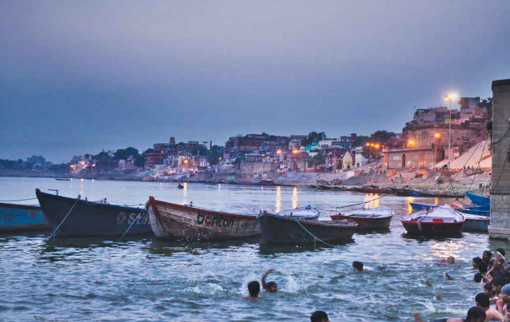 Featured in Top 10 Indian Cities by Sky Bird Travel & Tours, this image shows Varanasi, India during the Holi celebration.
