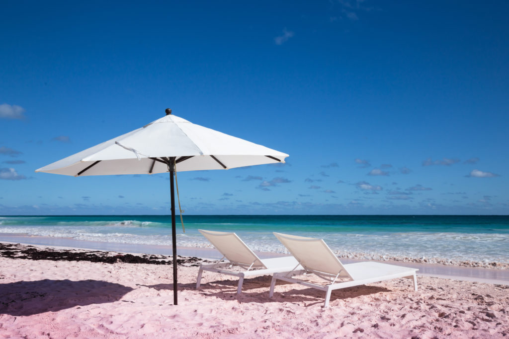 Featured in the blog "Top 10 Destination: The Bahamas" by Sky Bird Travel & Tours, this image shows the Pink Sands Beach.