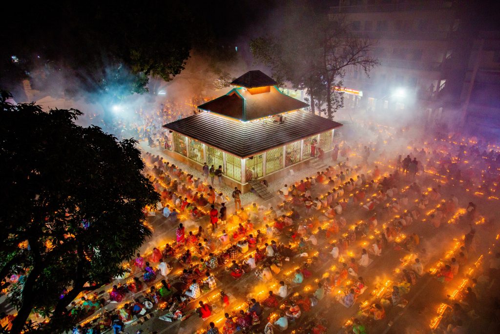 Featured in the blog Trending Travel Experiences of 2025 by Sky Bird Travel & Tours, this image shows a Bangladeshi Hindu festival at a temple.