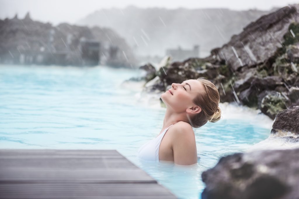 Featured in the blog Trending Travel Experiences of 2025 by Sky Bird Travel & Tours, this image shows a Woman enjoying blue lagoon.