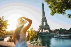 Woman in a white dress and sunhat standing by the river with the Eiffel Tower in the background, sunlit scene in Paris